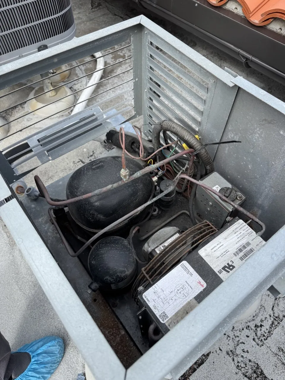Remote condensing unit for a walk-in wine cooler, opened up:
                         compressors, condenser coil and the condenser fan