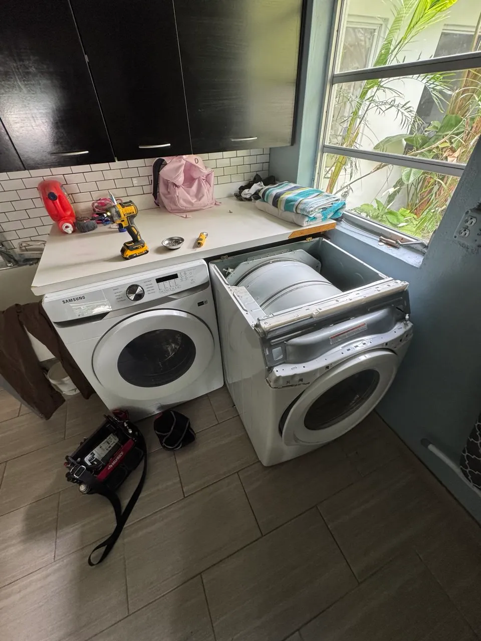 White LG stacked washer-dryer in a closet