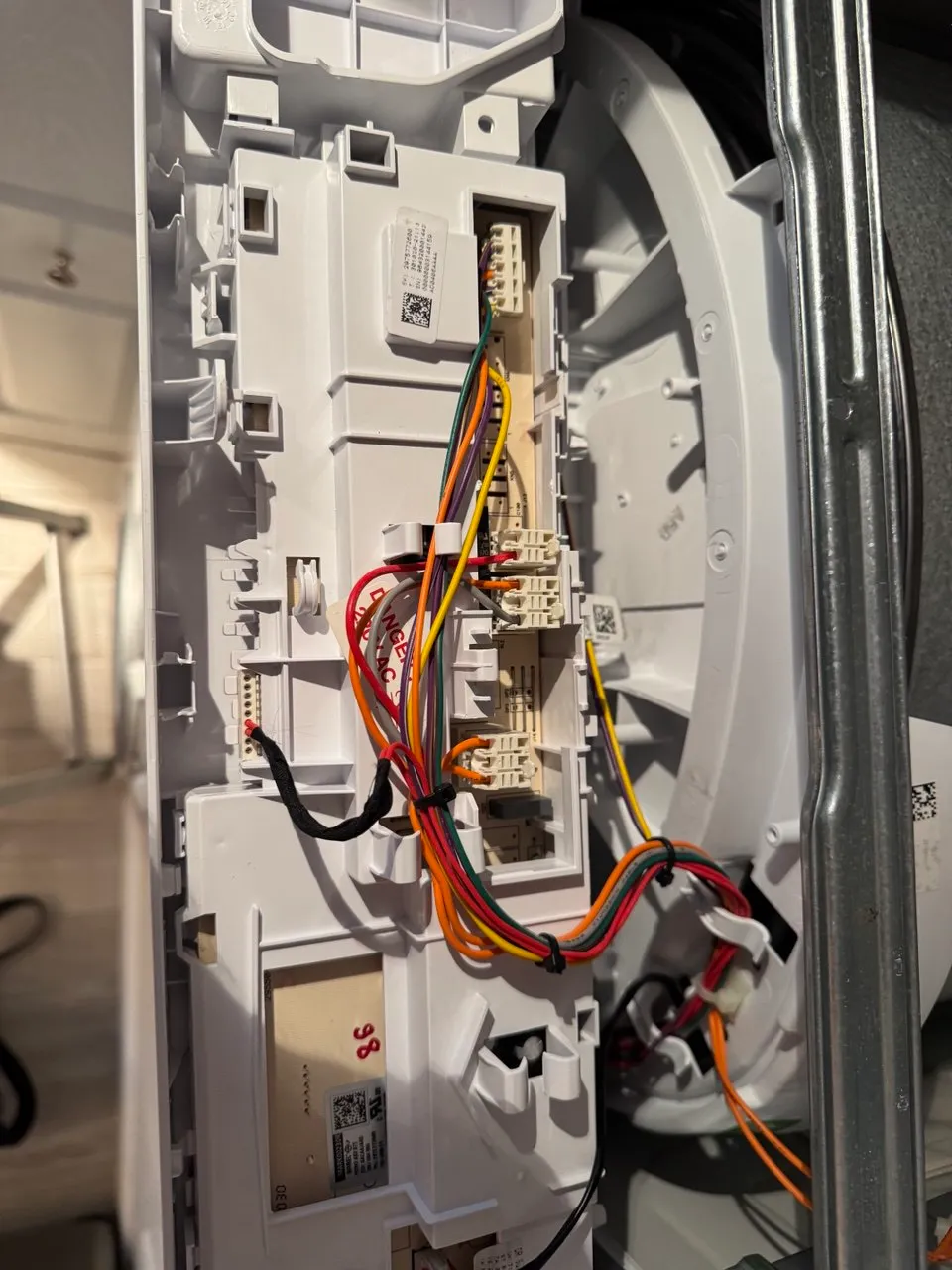 Washing machine control panel removed with the wiring harness exposed