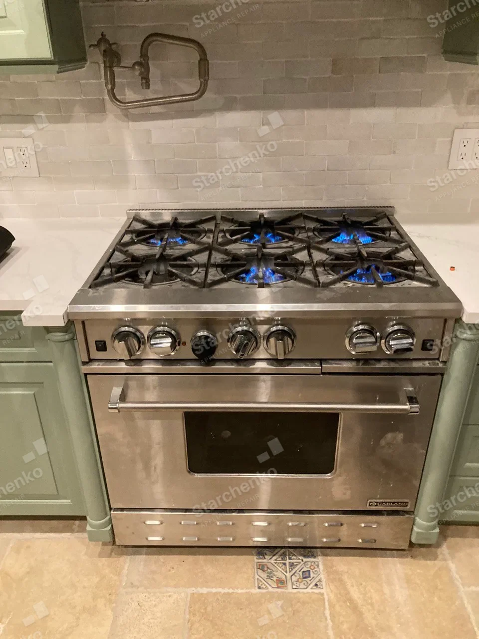 Professional Garland gas range with six burners lit