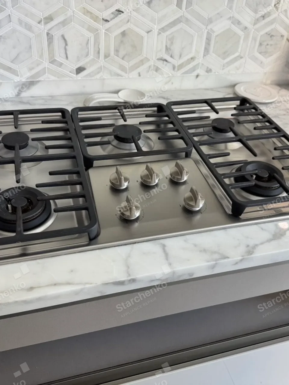 Jenn-Air gas cooktop installed in a marble countertop
