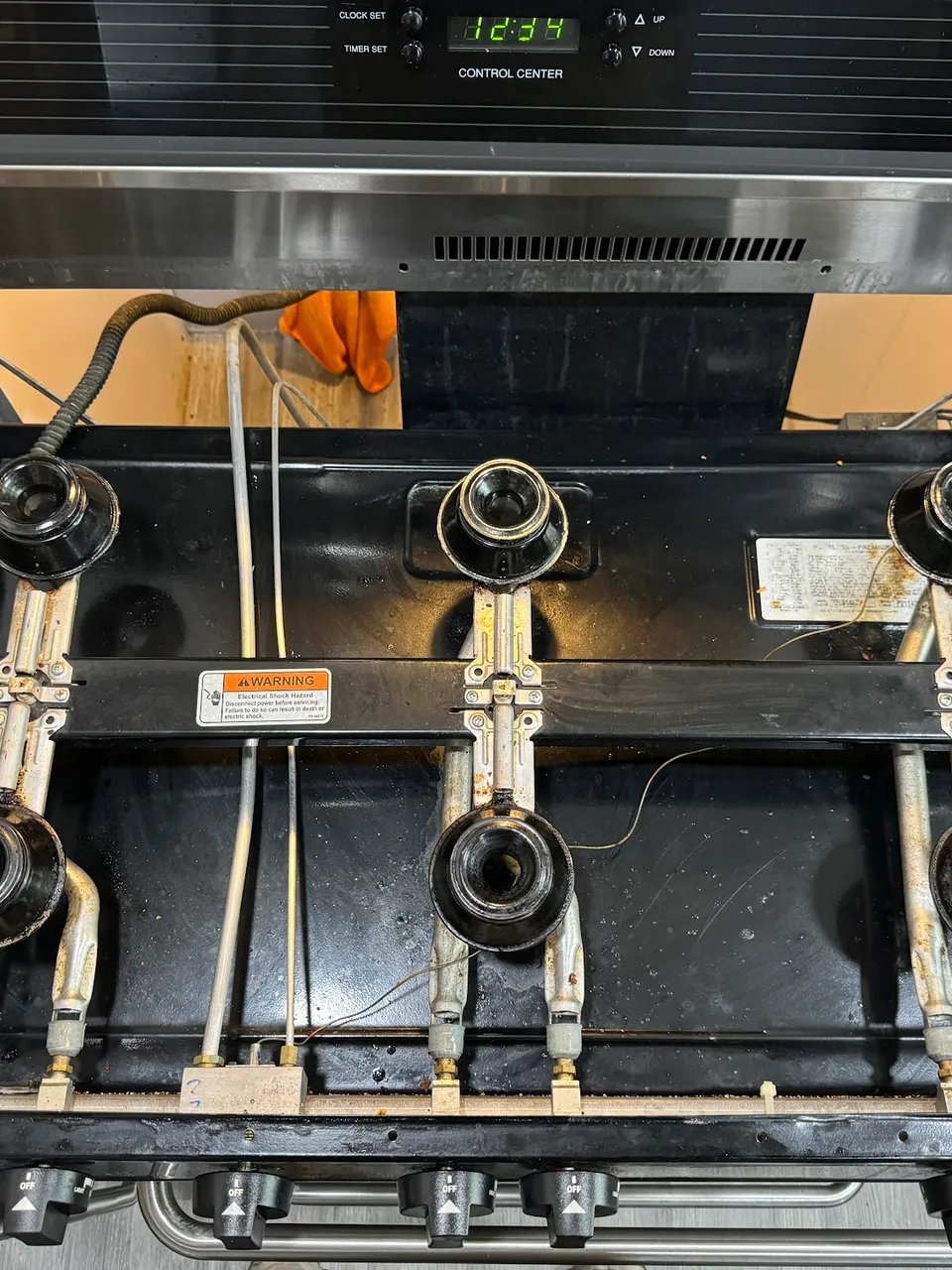 Cooktop lifted above the counter with the burner assemblies exposed