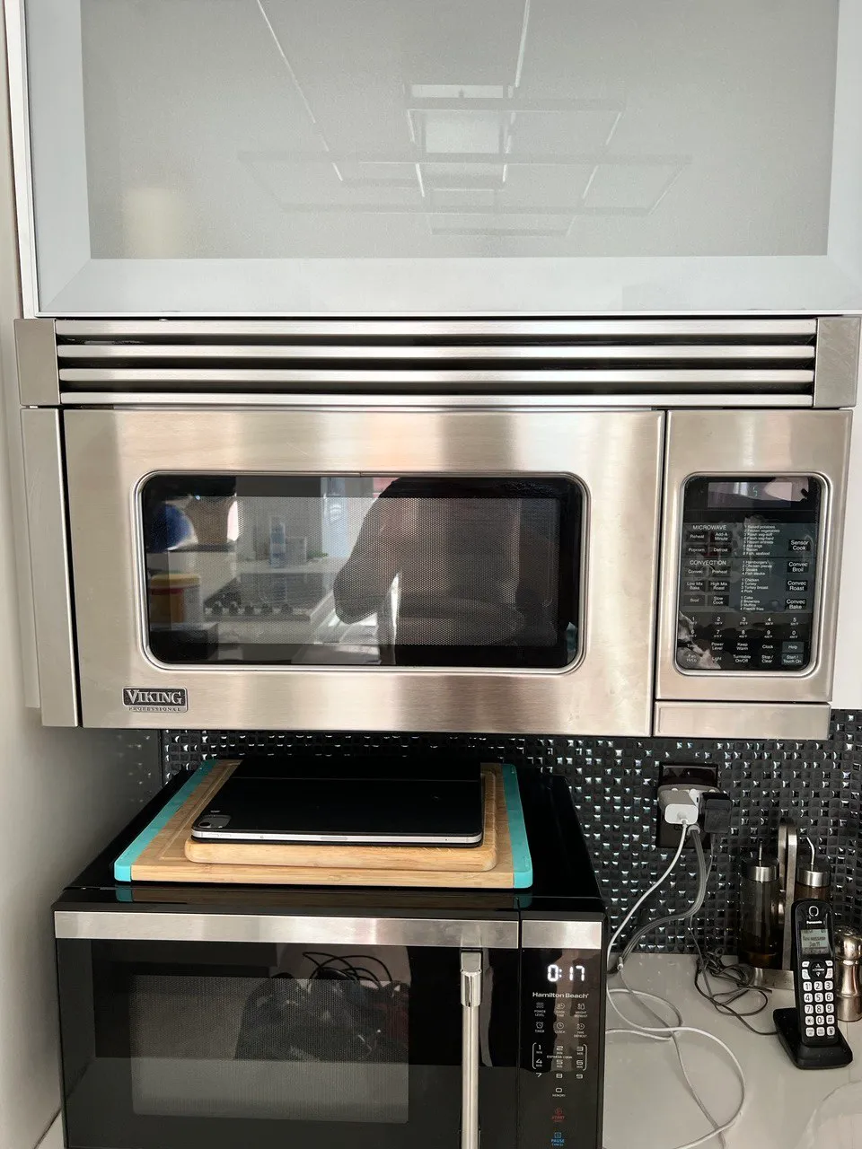 Over-the-range microwave mounted above a stainless range in a kitchen