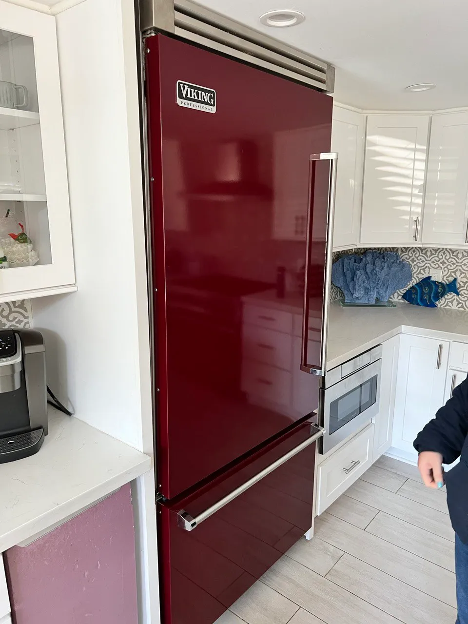 Burgundy Viking refrigerator in a white kitchen