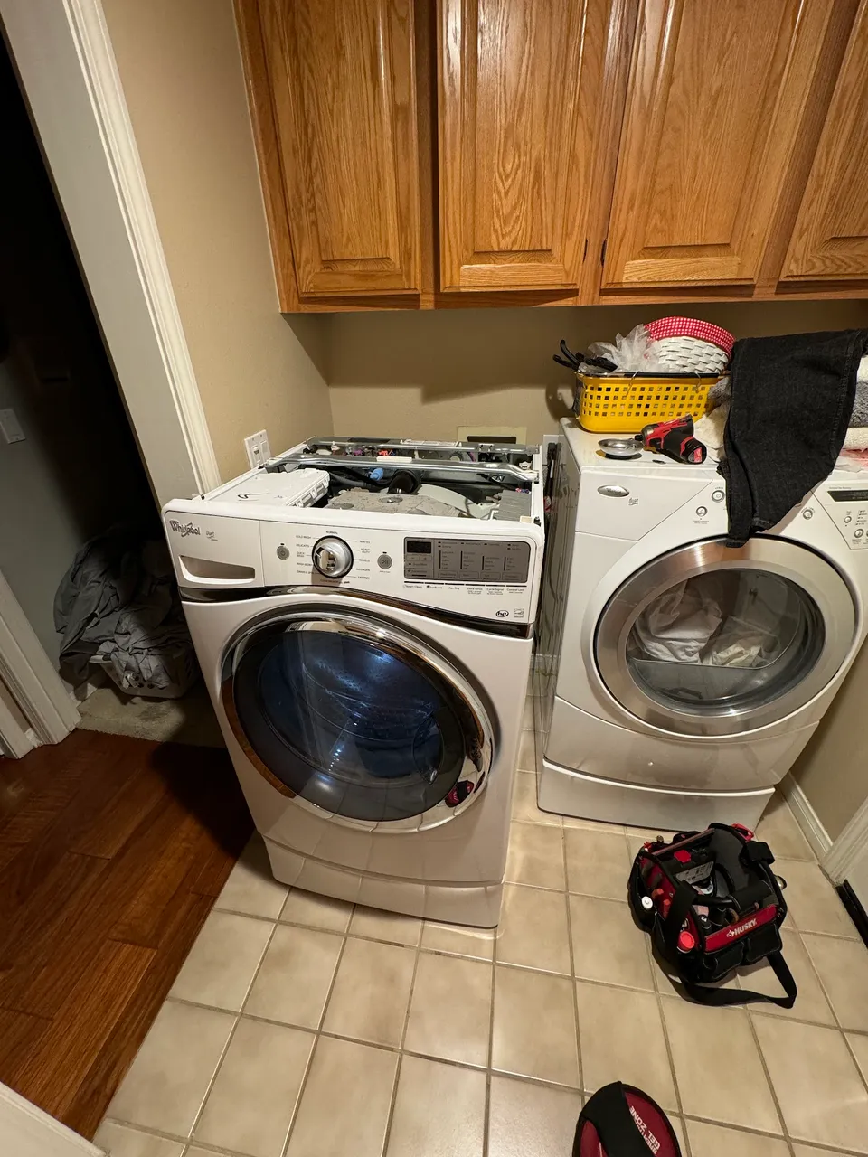 Front-load washer and dryer pair with the top panels removed