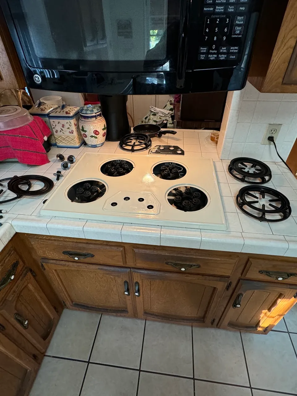 Gas cooktop disassembled with the burner assemblies exposed