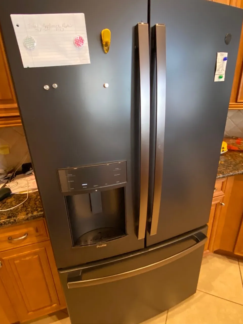 French-door refrigerator with an ice and water dispenser in a wood kitchen