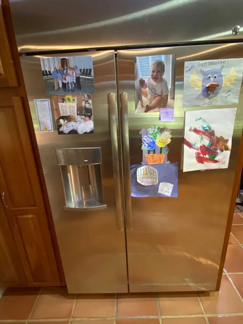 Stainless side-by-side refrigerator with an ice dispenser in the door