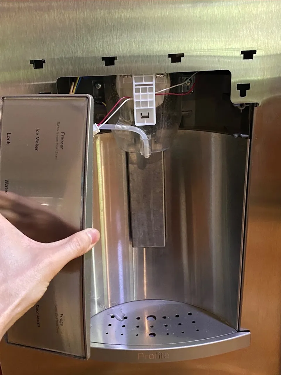 Refrigerator ice and water dispenser with the front panel removed