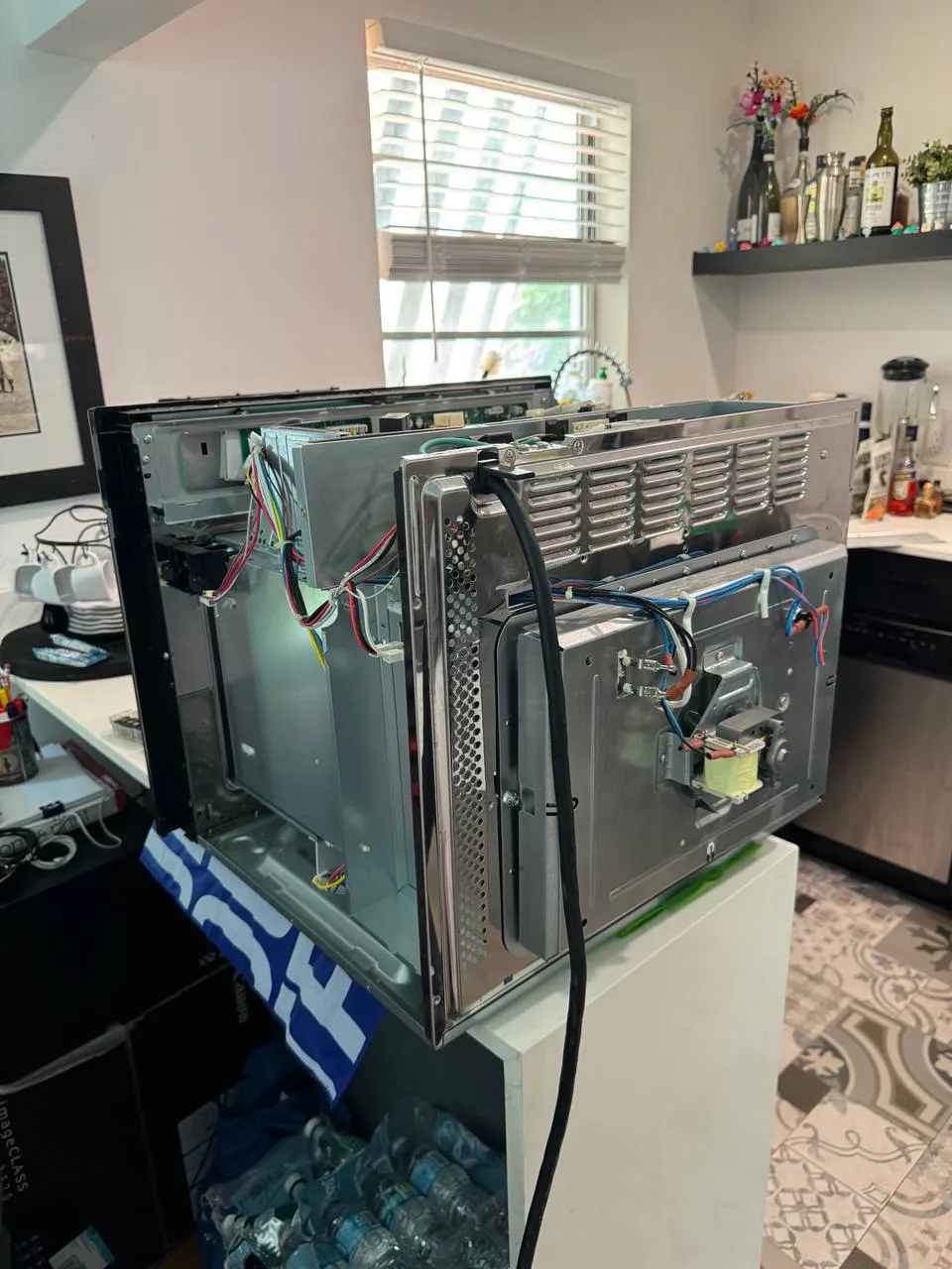 Convection oven taken apart with the back panel off and wiring exposed
