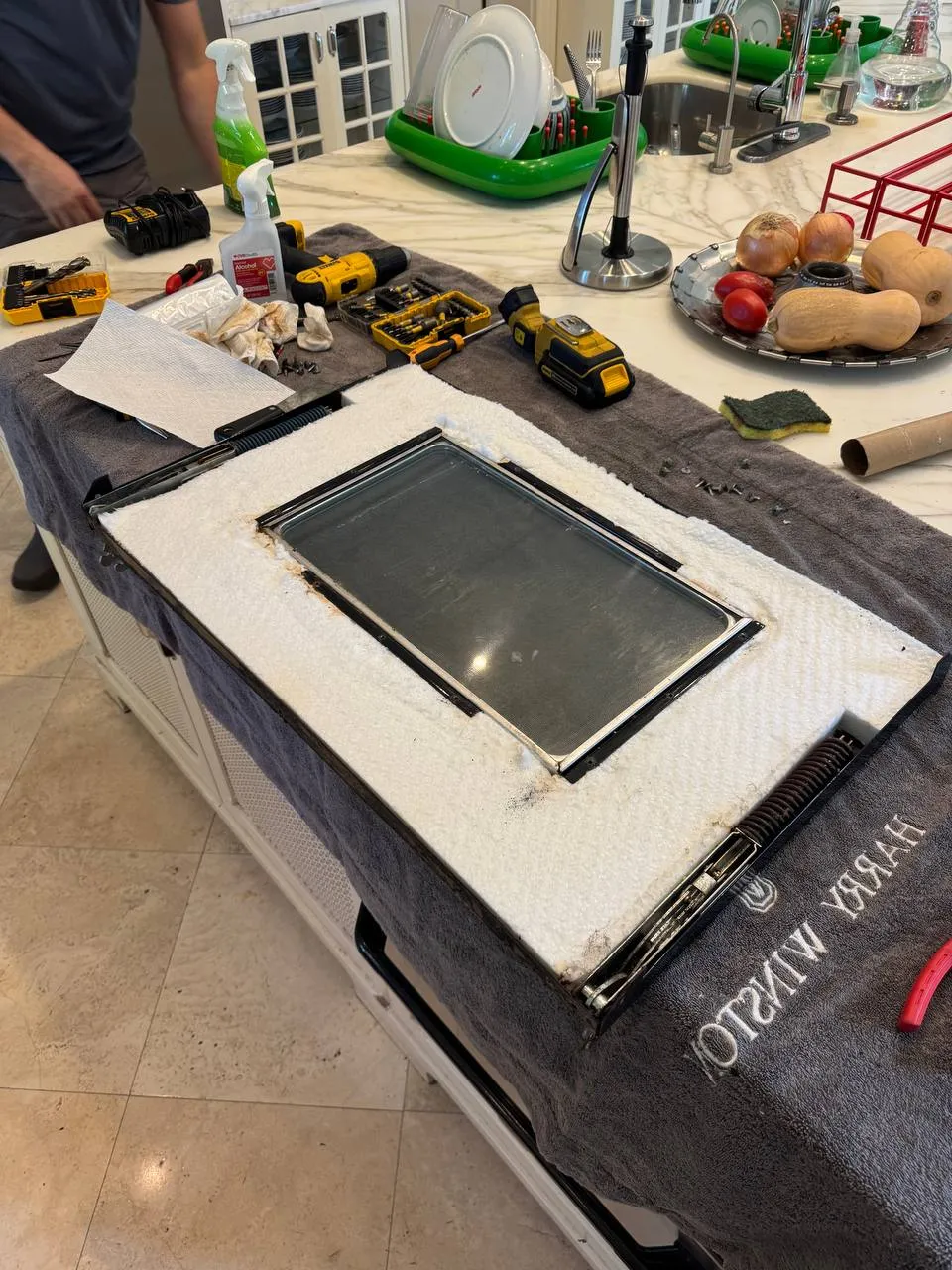 Oven door glass removed and laid out on the kitchen island