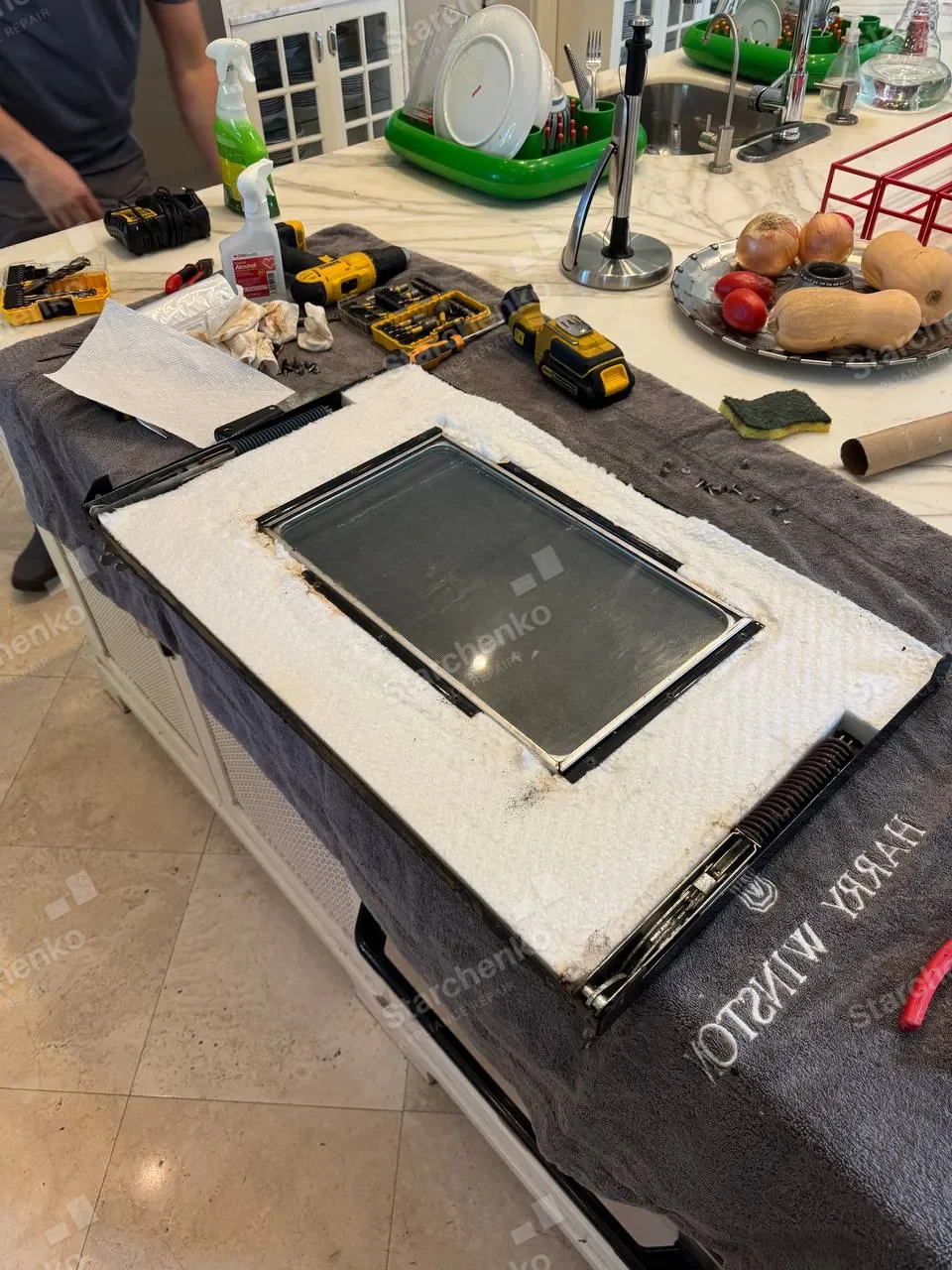 Viking oven door glass removed and laid out on the kitchen island