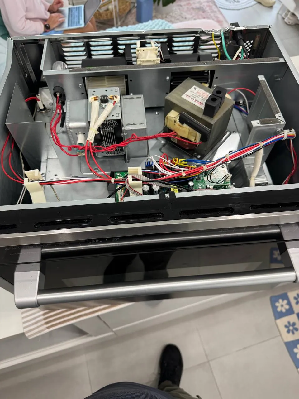 Microwave drawer taken apart with the transformer and wiring exposed