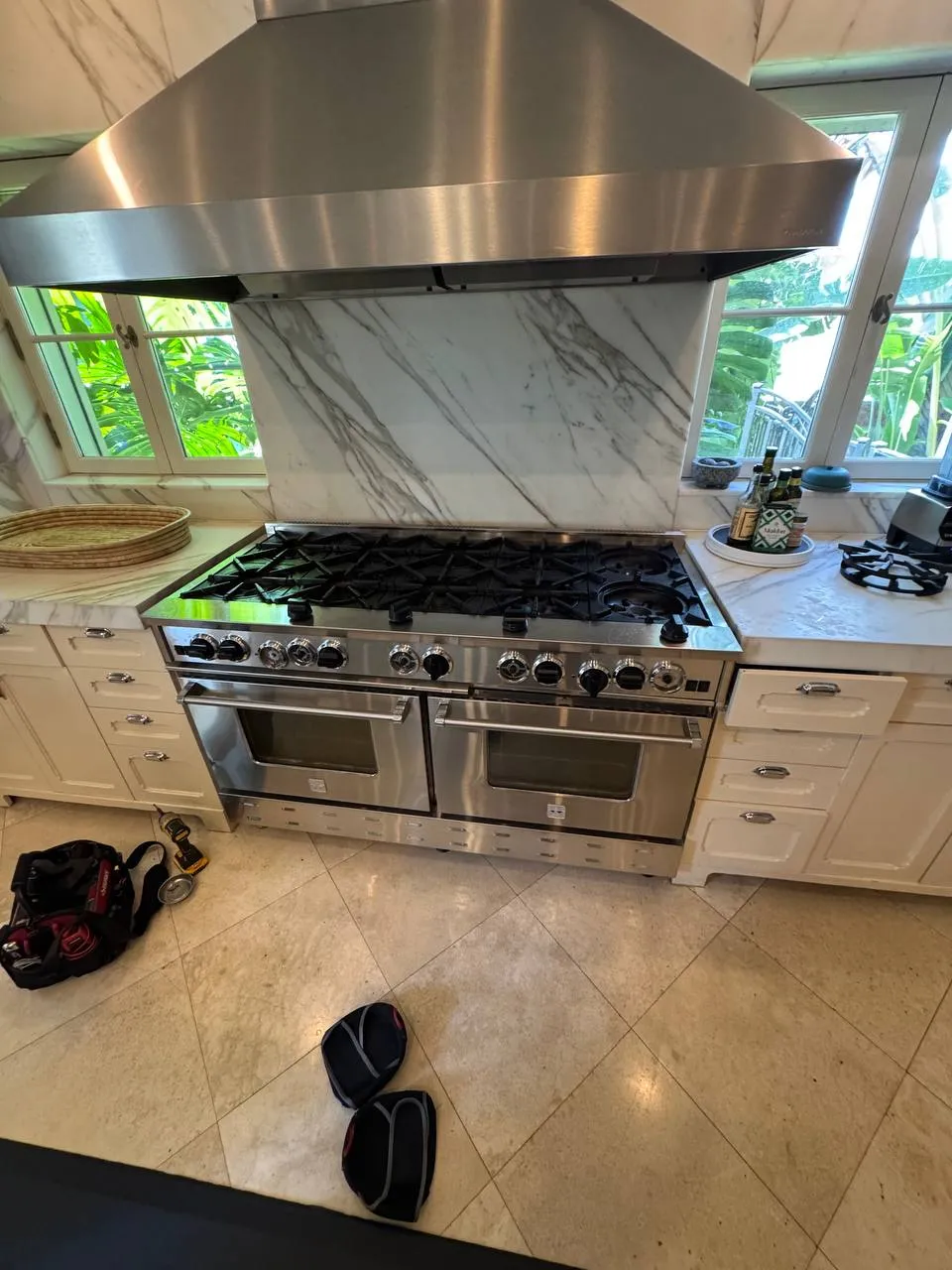 Double pro-style gas range under a large stainless hood