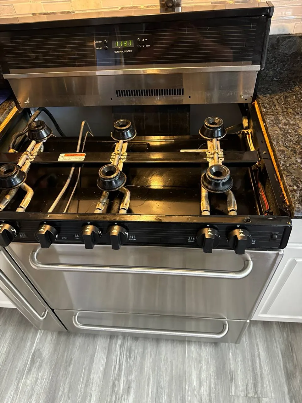Brass burners on a pro-style gas range seen from above