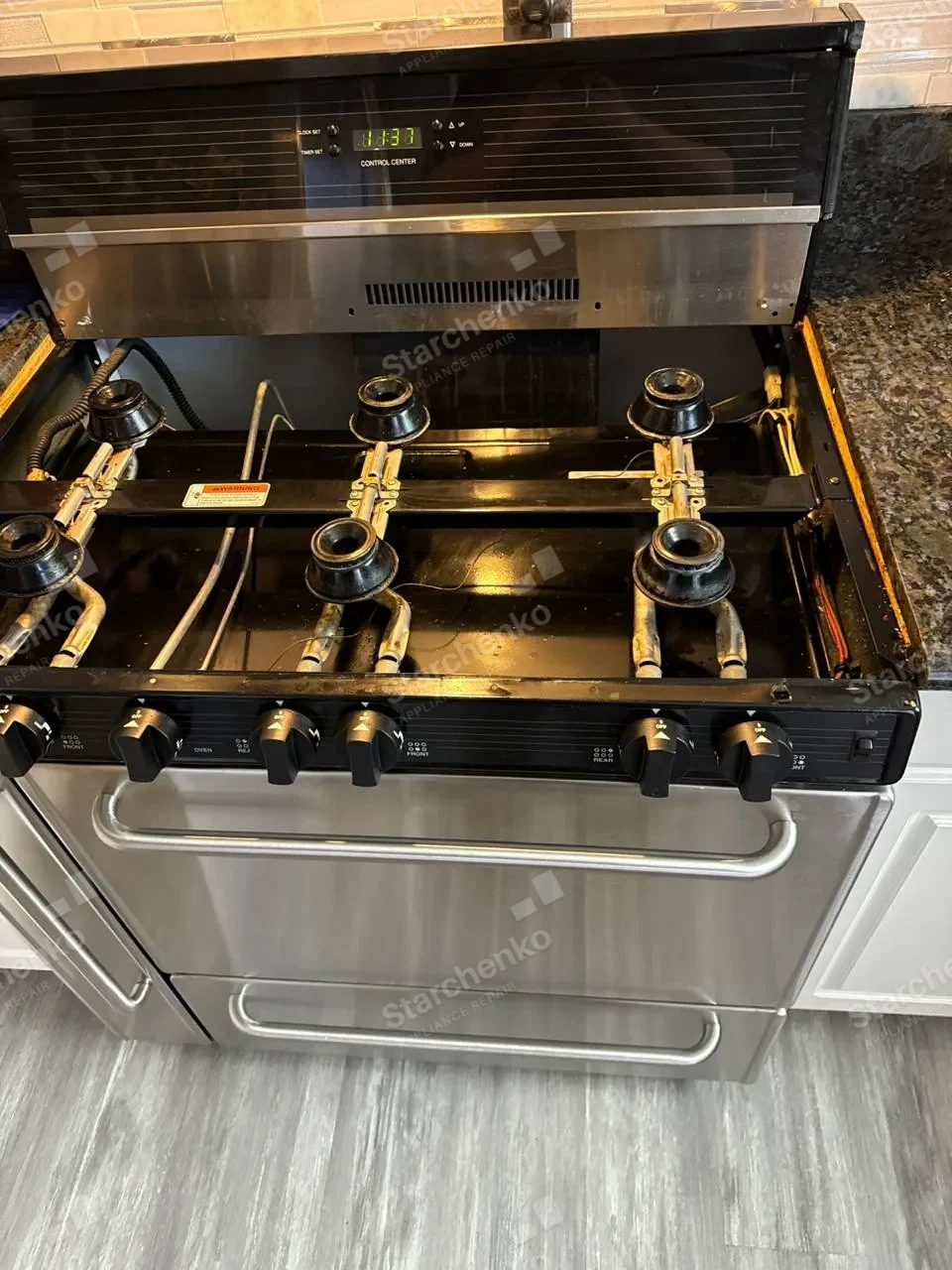 Brass burners on a pro-style Thermador gas range seen from above