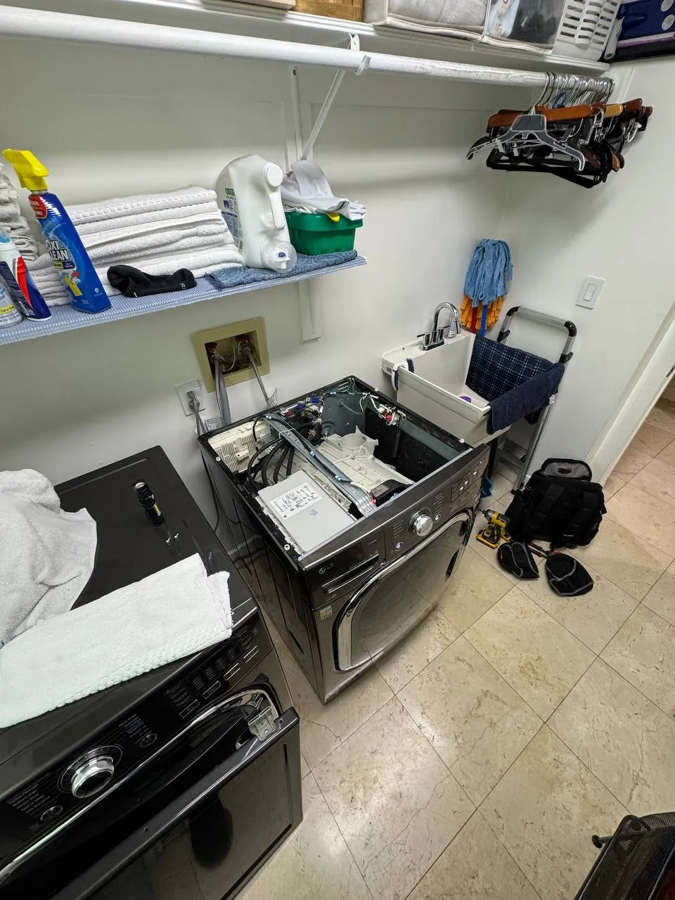 Front-load washer with the top panel off and the control area exposed