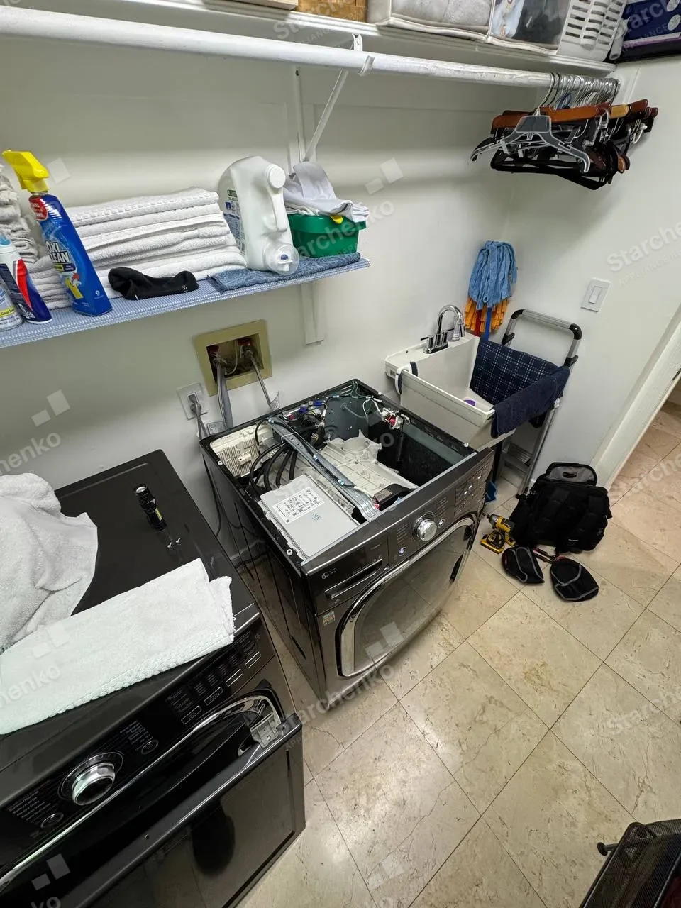 LG front-load washer with the top panel off and the control area exposed