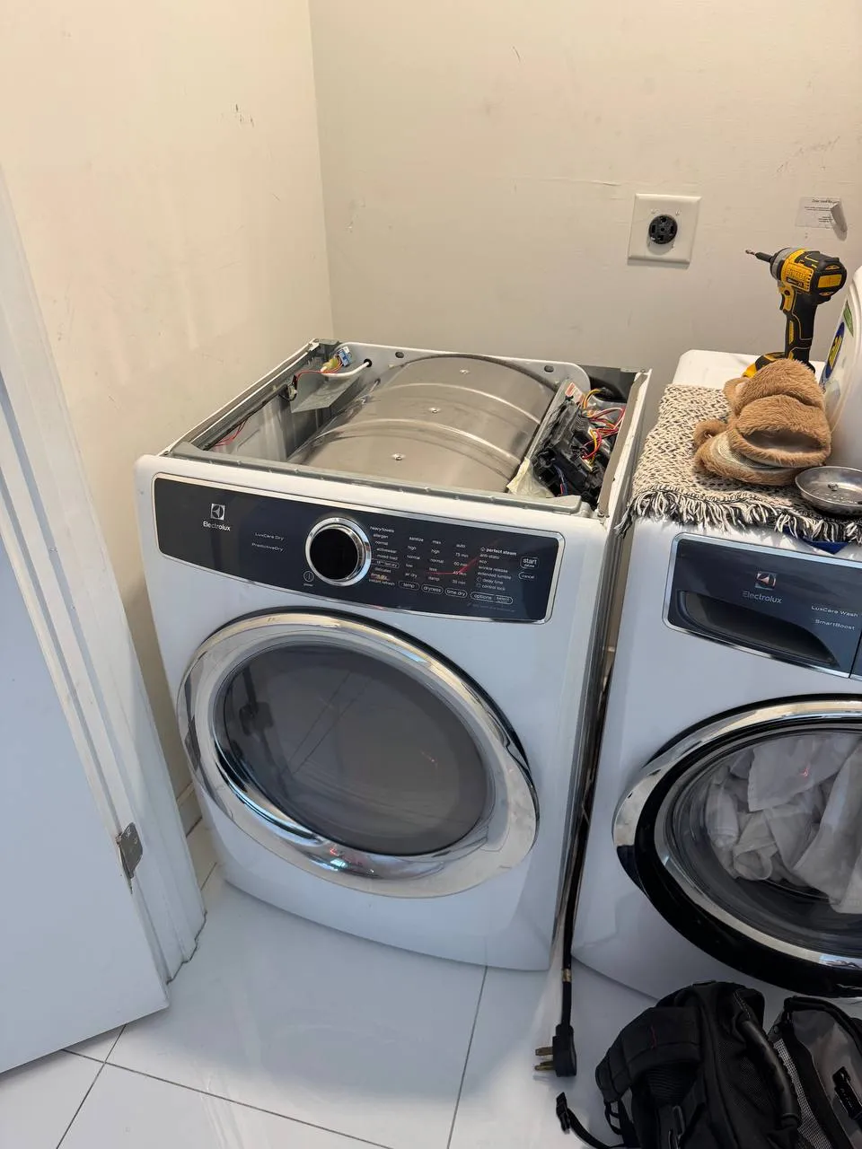 Electrolux dryer with the top panel removed and drum and wiring exposed