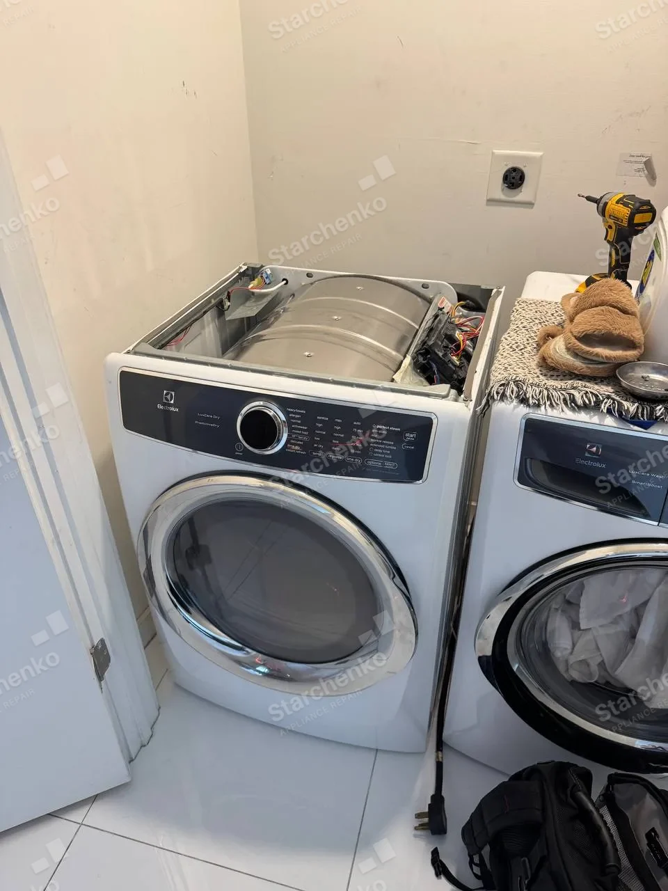 Electrolux dryer with the top panel removed and drum and wiring exposed