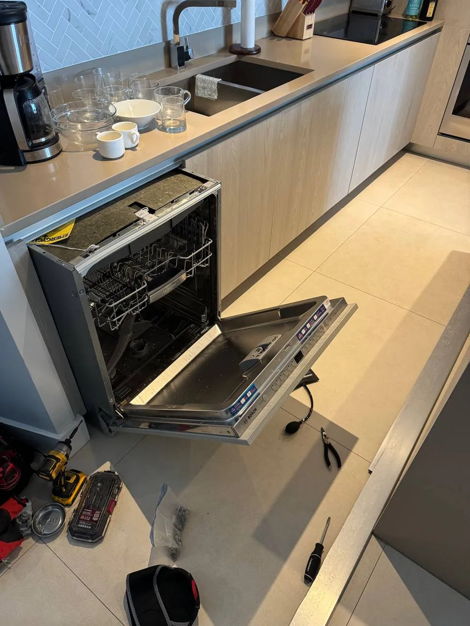 Panel-ready dishwasher with the door open and the control strip detached