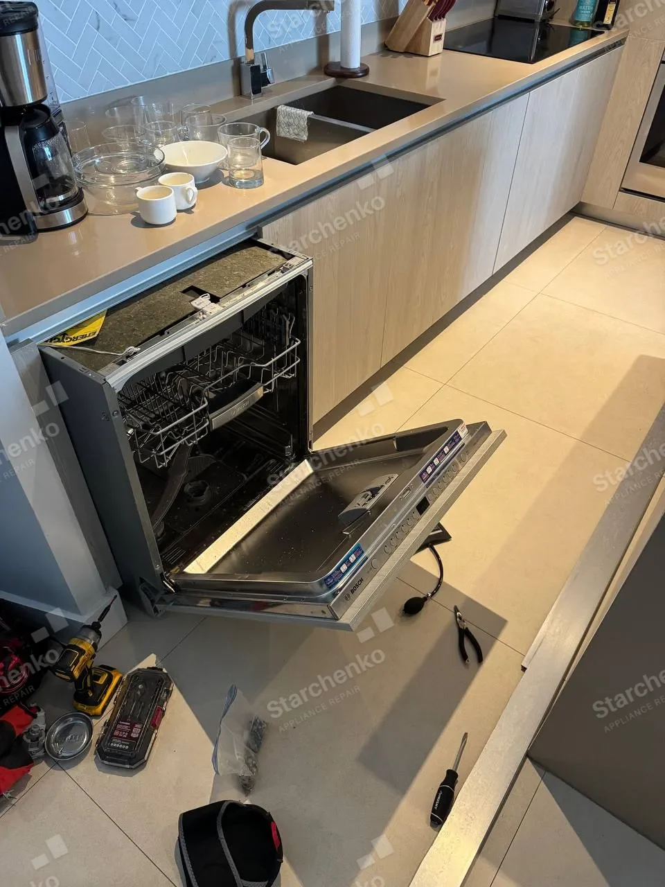 Panel-ready Bosch dishwasher with the door open and the control strip detached