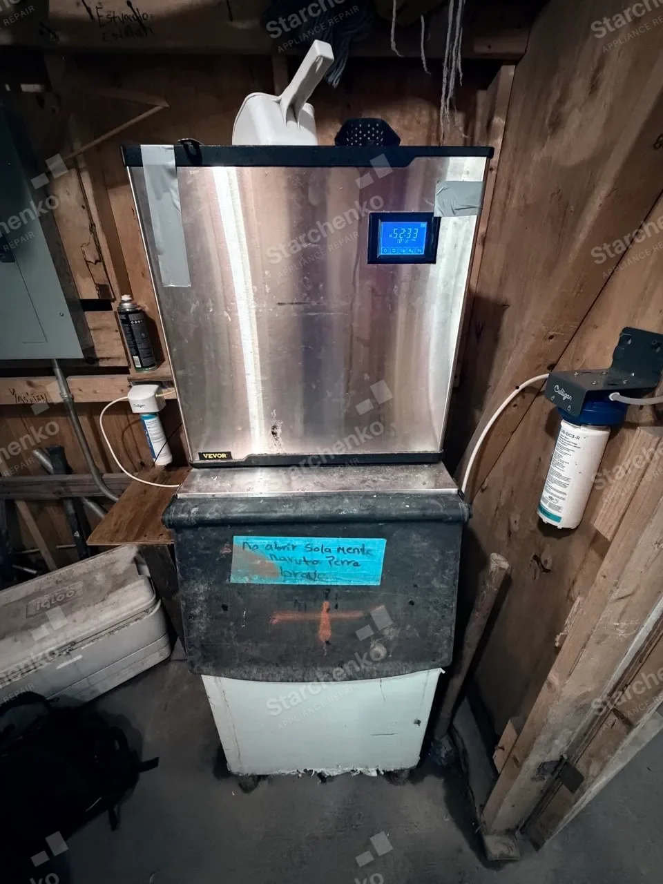 Floor-standing VEVOR commercial ice machine on a storage bin beside a water filter