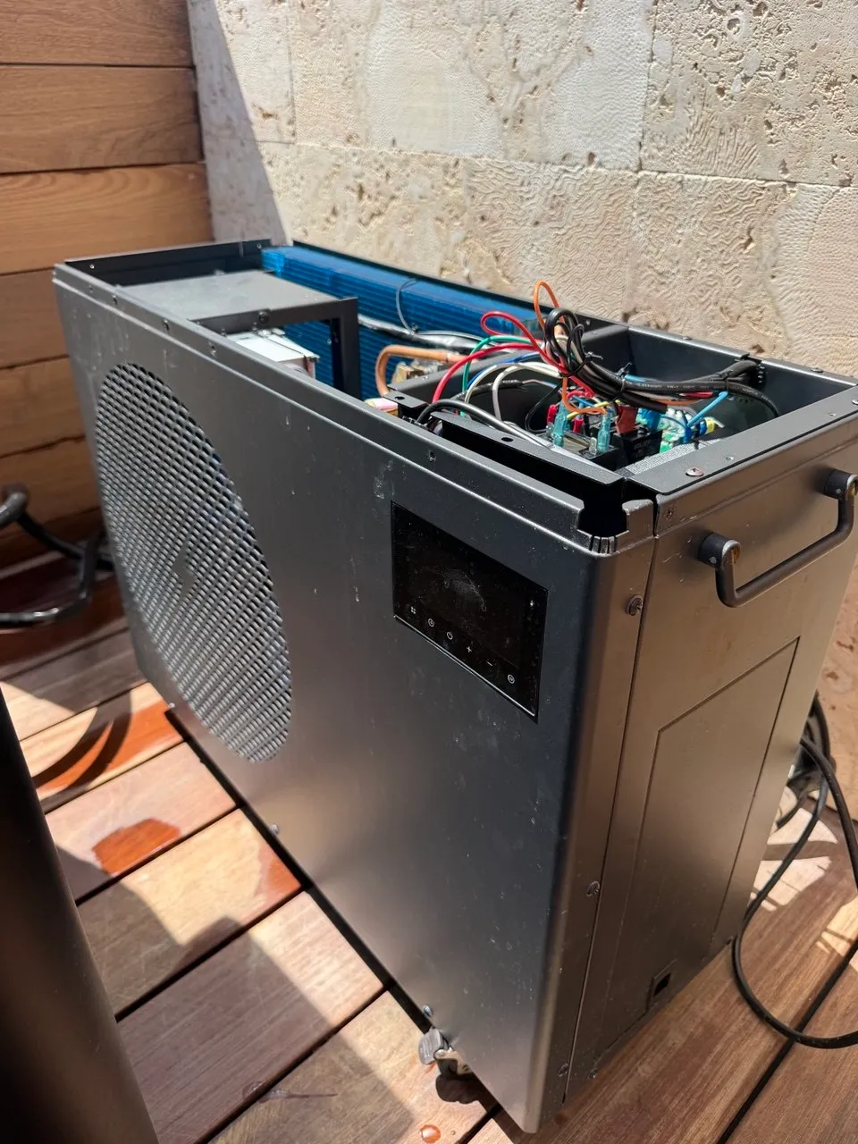 Outdoor commercial condensing unit with the top cover removed and wiring and coil visible