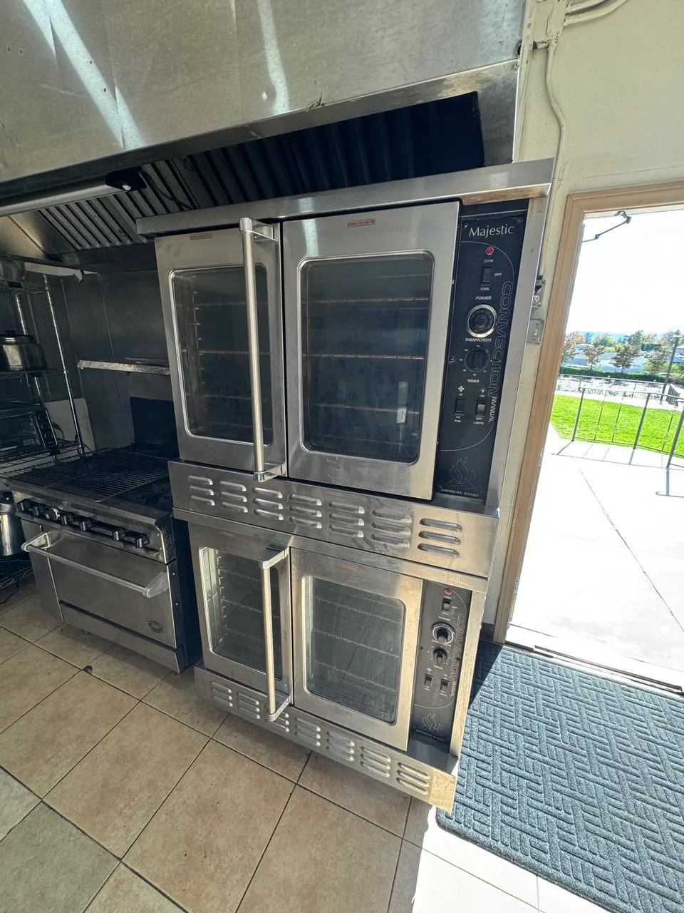 Two American Range Majestic commercial convection ovens stacked in a restaurant kitchen