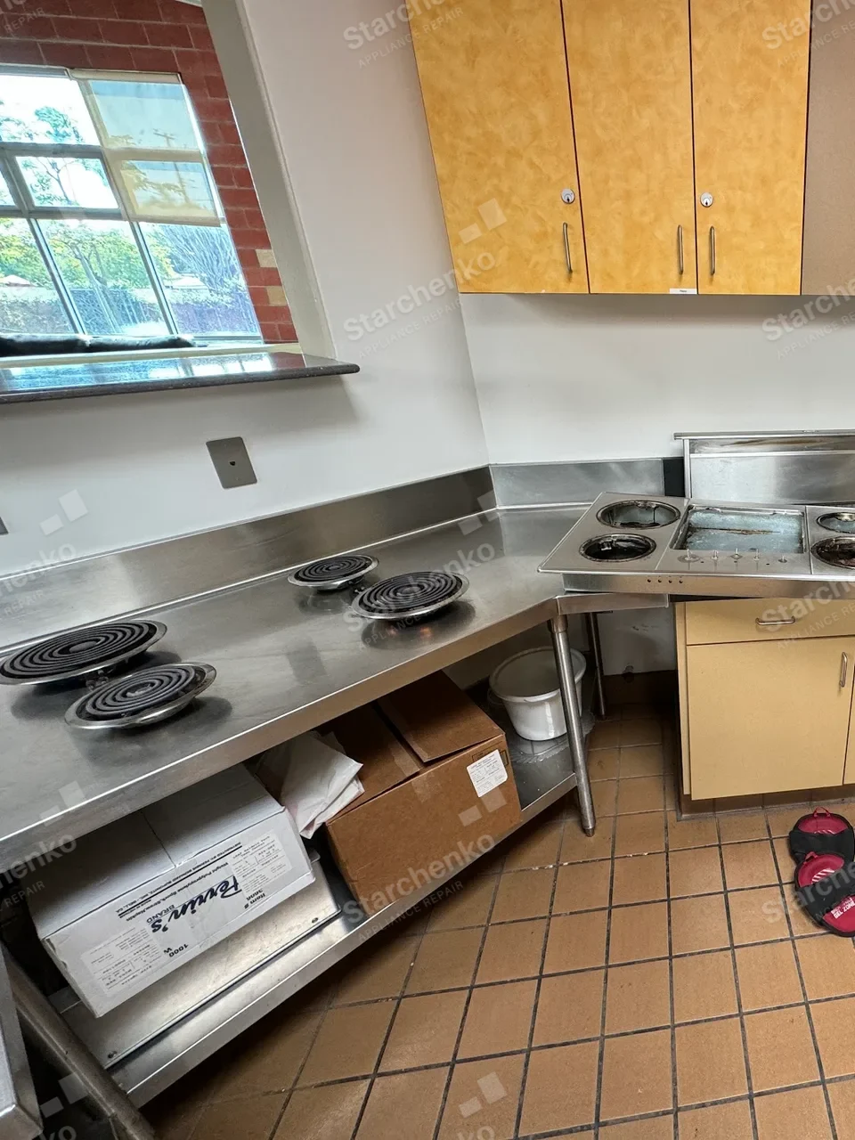 Four Southbend electric coil cooktop elements set into a stainless work counter