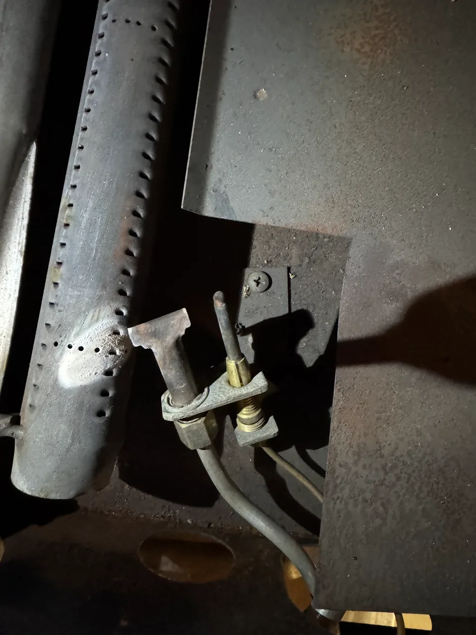 Commercial oven burner and pilot assembly exposed for service