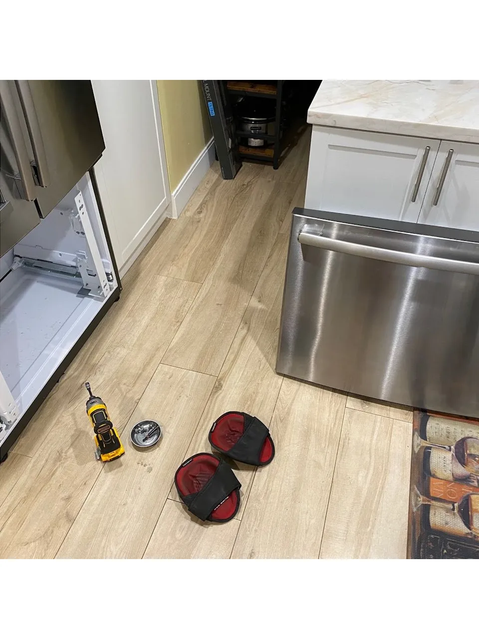 Refrigerator with its lower drawer open during a service call