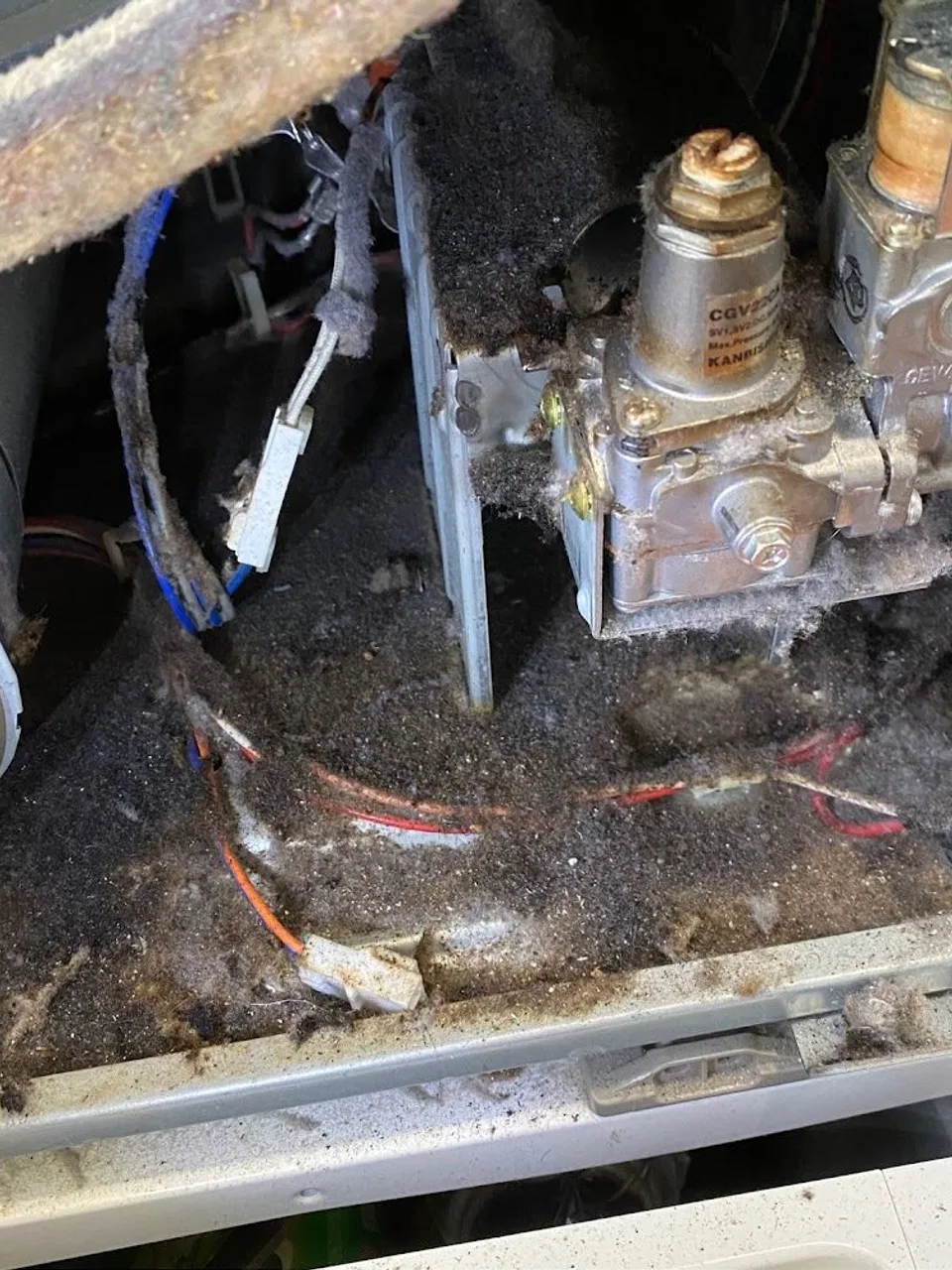 Gas dryer with the gas valve assembly and igniter exposed under the drum