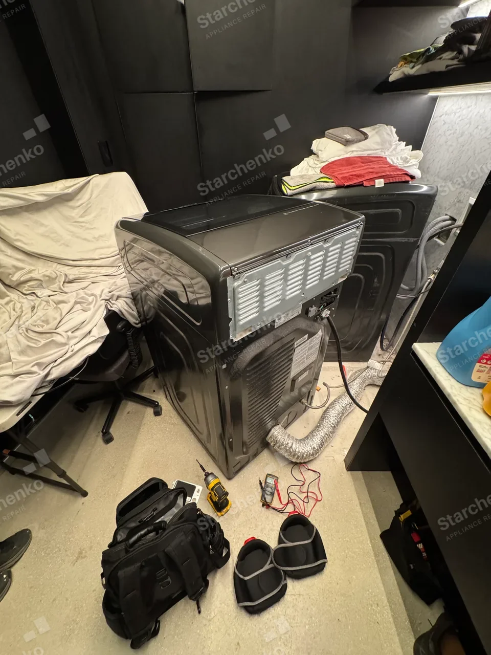 Samsung dryer laid on its side with the top open to reach the thermistor