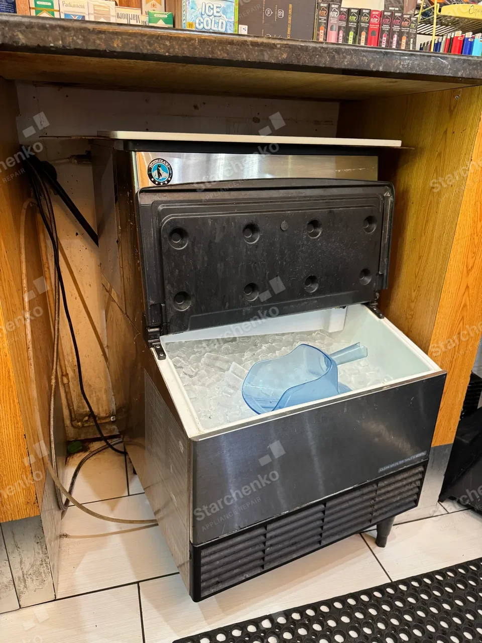 Hoshizaki commercial ice machine with the storage bin open and ice inside