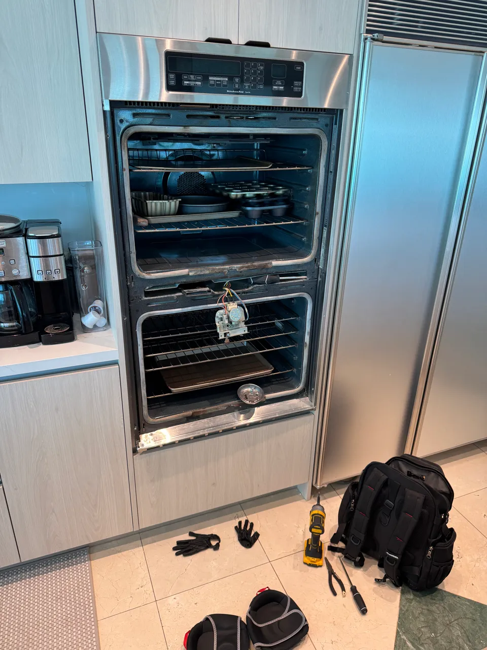 KitchenAid double wall oven with both doors open and the door lock assembly removed