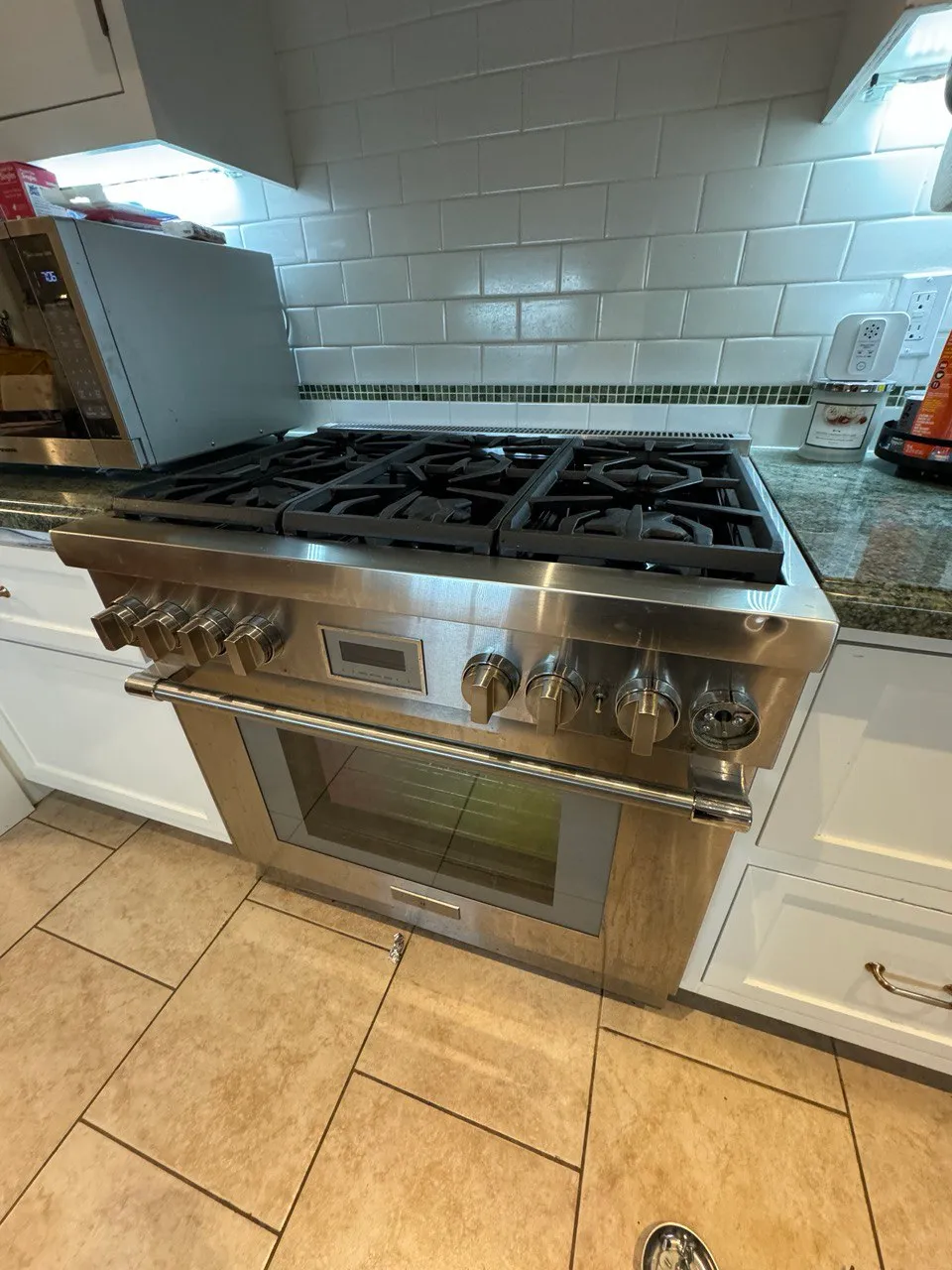 Wolf pro-style stainless gas range with six burners and a built-in oven in a home kitchen