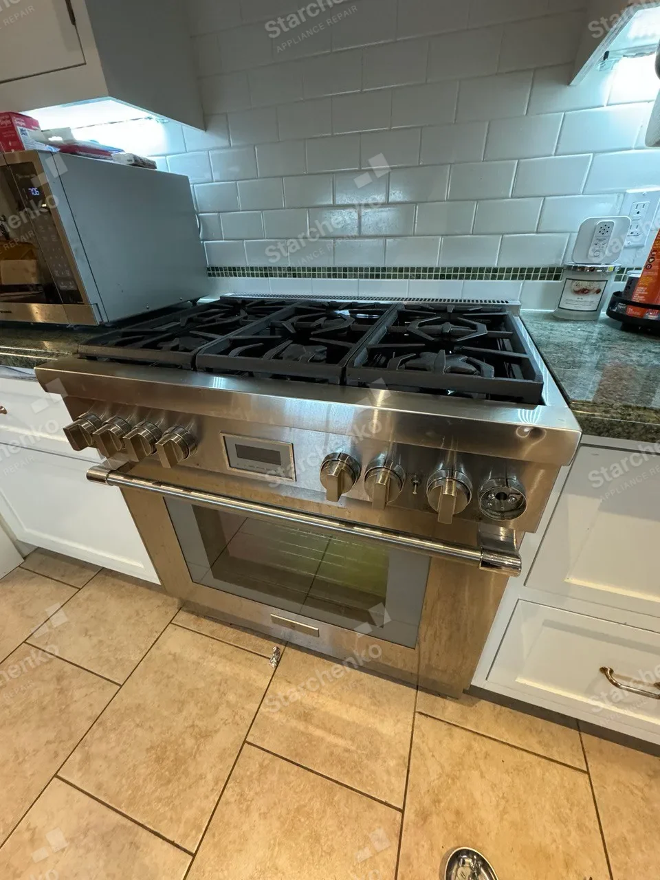 Wolf pro-style stainless gas range with six burners and a built-in oven in a home kitchen