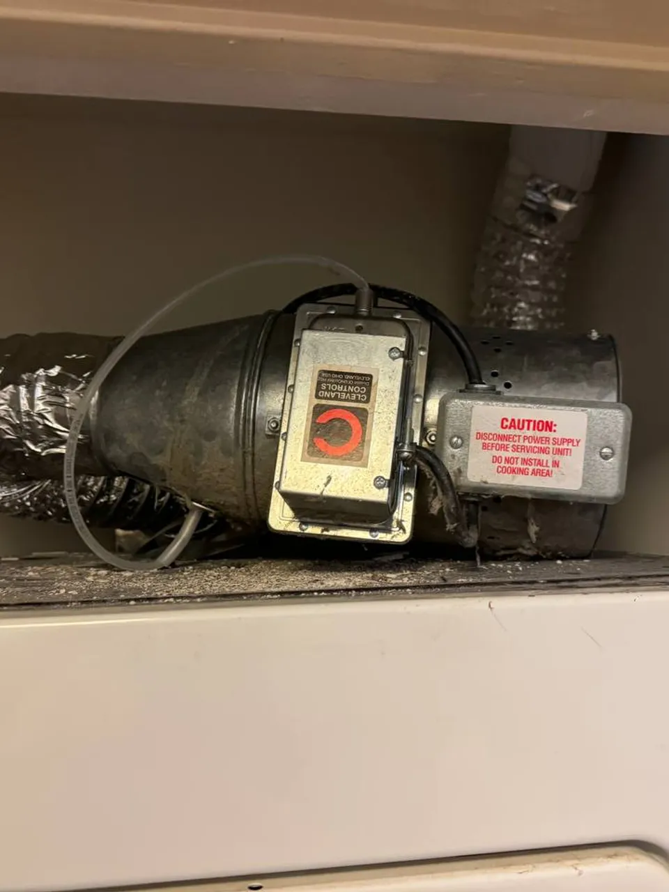 Kenmore dryer exhaust booster fan fitted on the vent duct above the machine