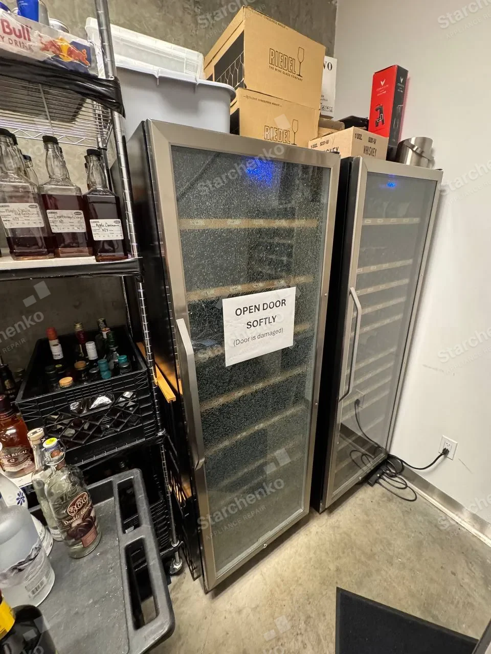 Two U-Line glass-door wine cabinets side by side, the left one with shattered door glass
