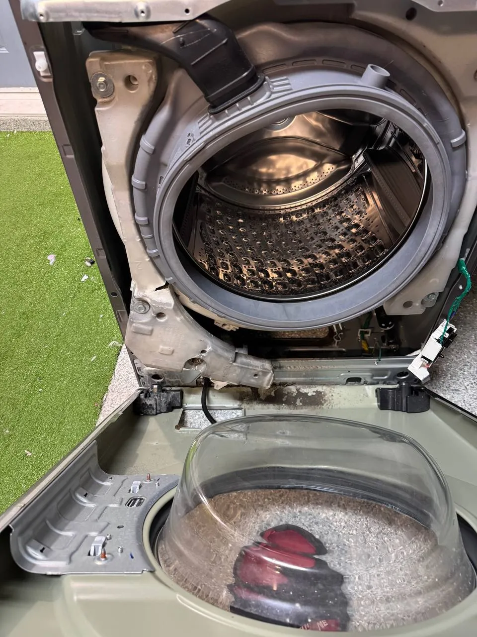 Samsung front-load washer with the door off and the tub and door boot exposed