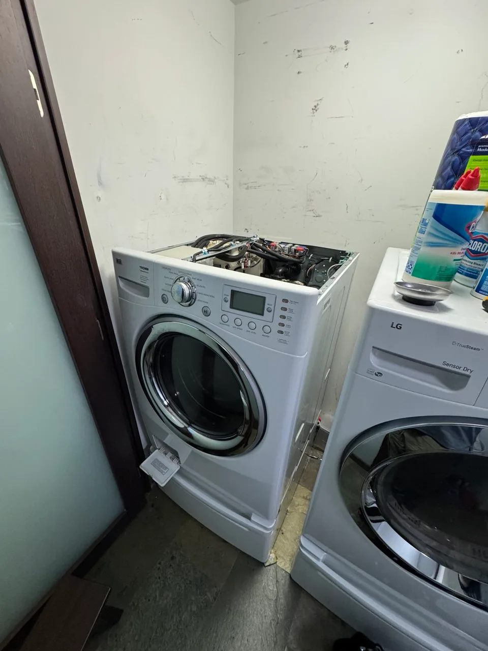 LG front-load washer on a pedestal with the top removed