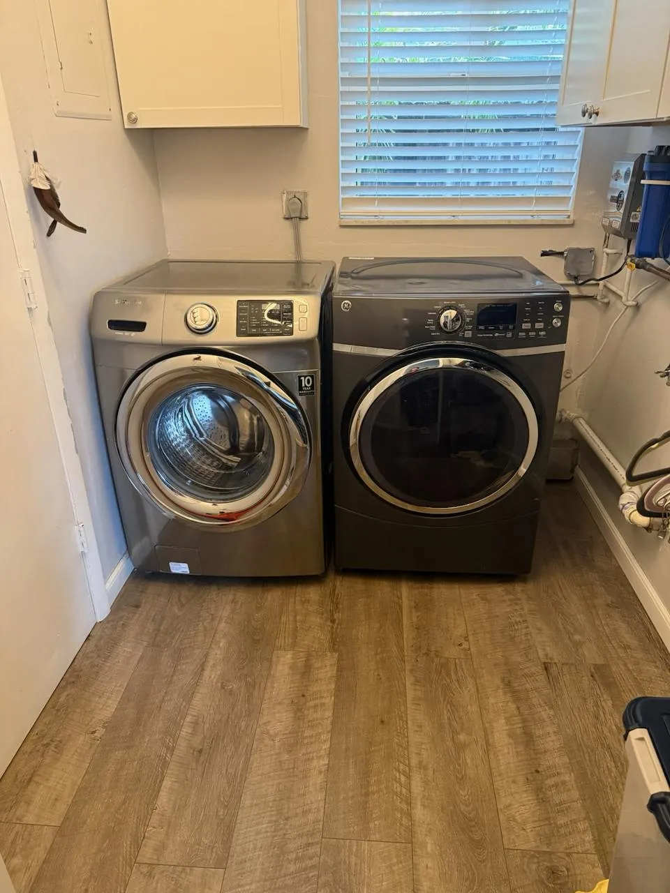 Samsung front-load washer and dryer pair standing side by side in a laundry room