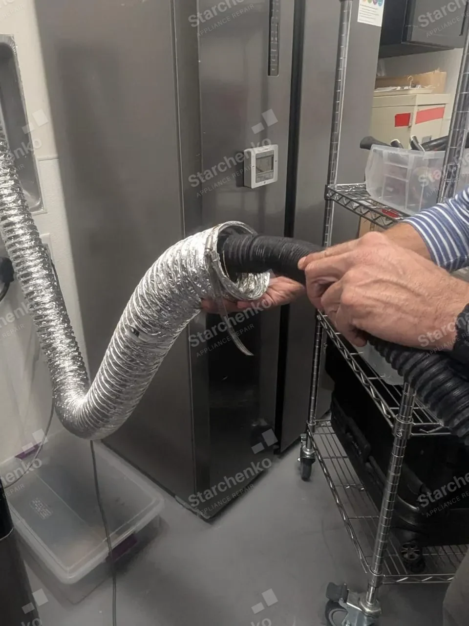 Technician joining the flexible vent duct of a commercial dryer with a clamp during a vent cleanout