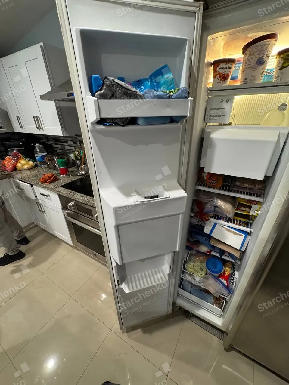 Open Whirlpool side-by-side refrigerator with food in the freezer and refrigerator sections