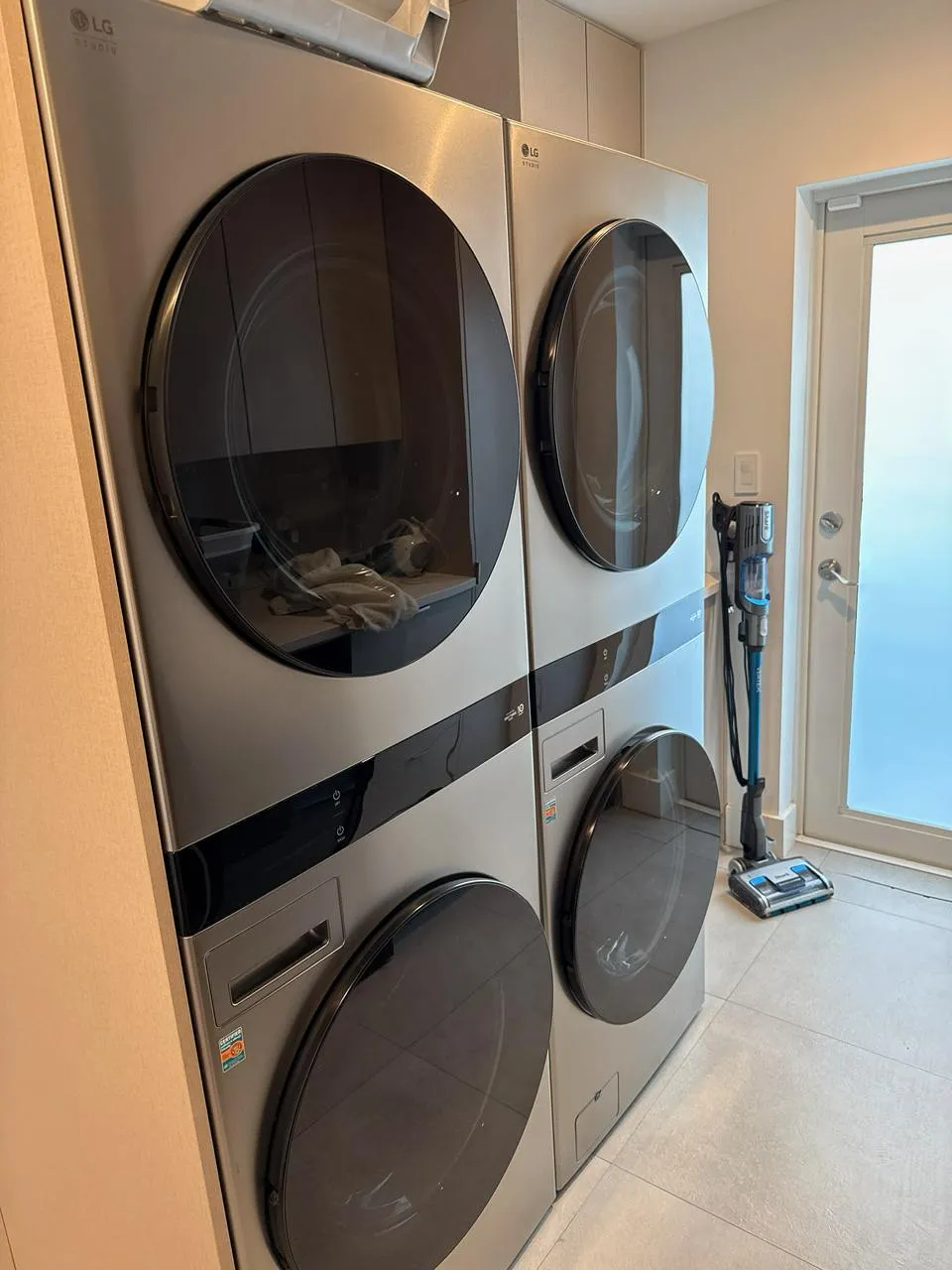 Two complete LG Studio WashTower laundry columns in a bright laundry room