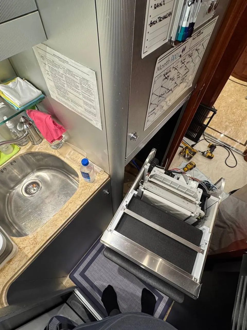 U-Line ice maker removed from cabinetry aboard a yacht with service tools nearby