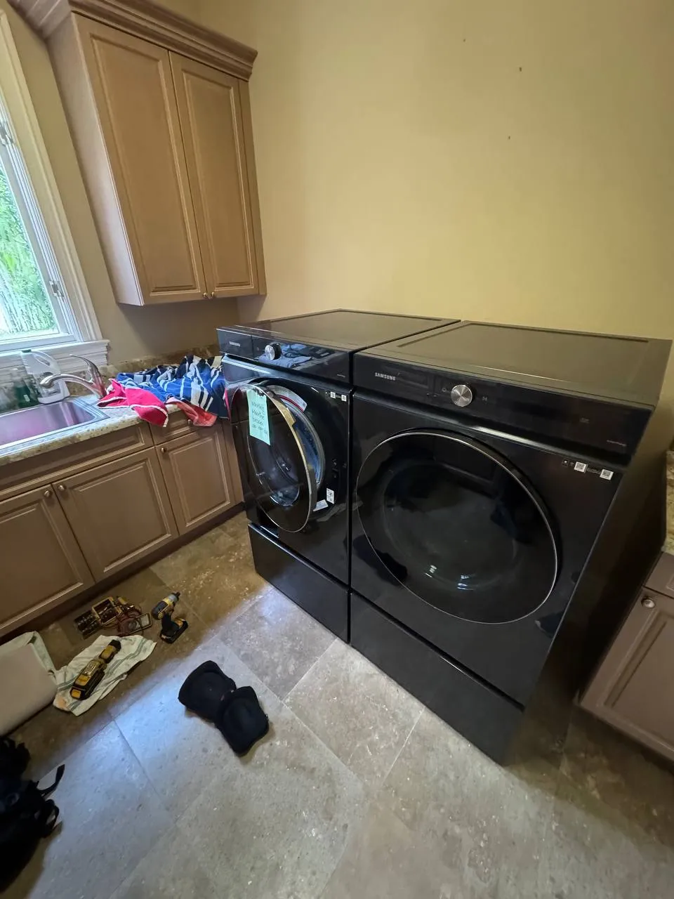 Samsung washer and dryer pair in black with the washer door open