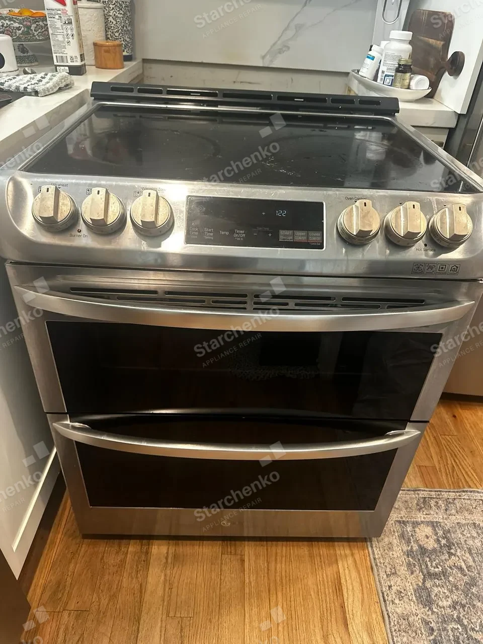 Stainless LG double-oven range with a black glass cooktop