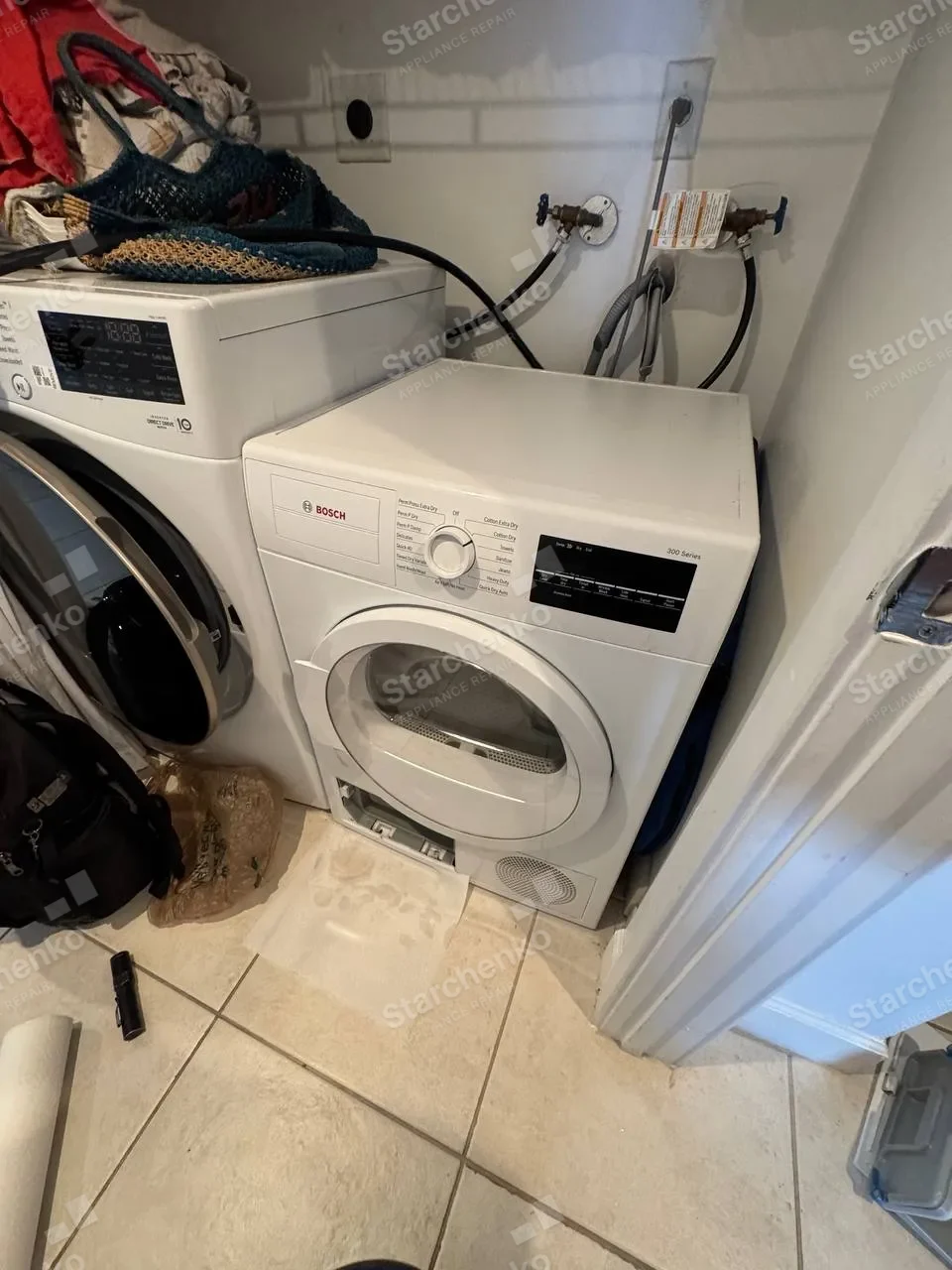 Bosch dryer beside a washer with its lower service hatch open